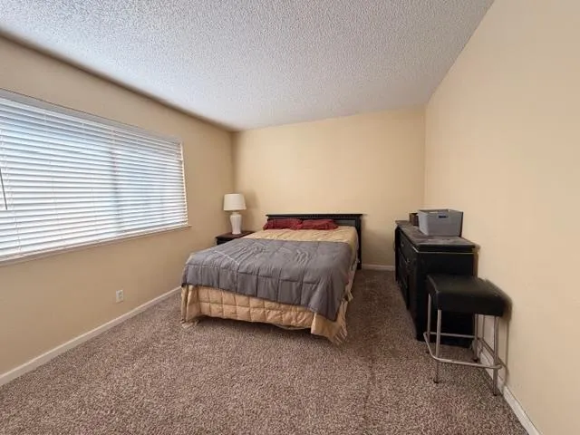 a bedroom with a bed and a chair