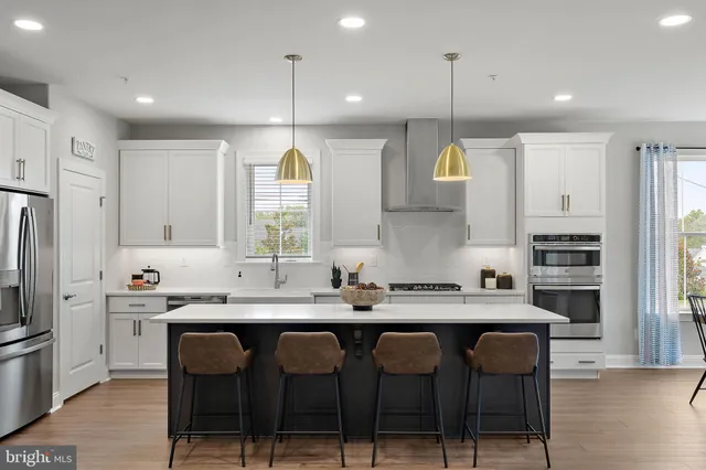 a kitchen with stainless steel appliances a sink stove and refrigerator
