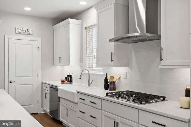 a kitchen with stainless steel appliances a cabinets and a stove top oven