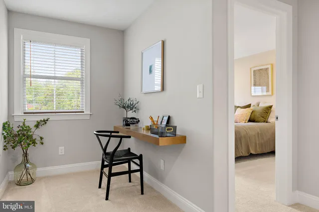 a work room with furniture and potted plant