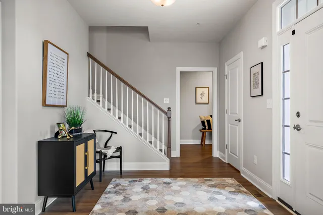 a view of entryway with wooden floor and stairs