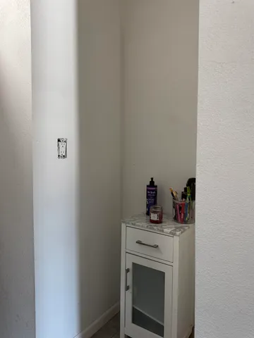 a view of a workspace with furniture and wooden floor