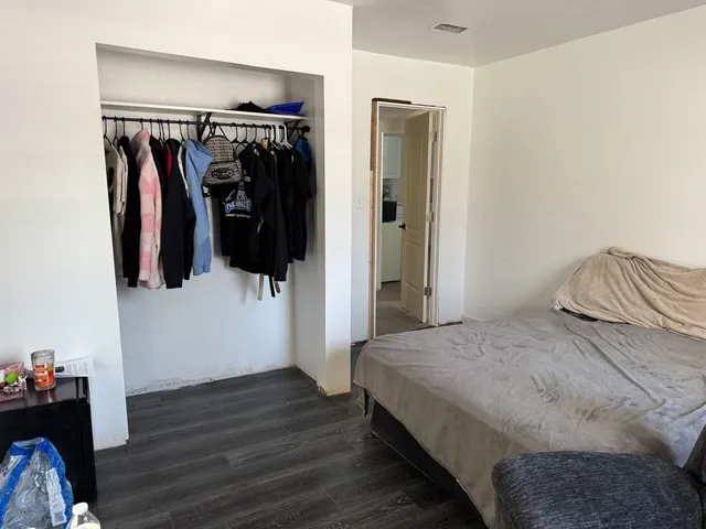 a bedroom with a bed and a television