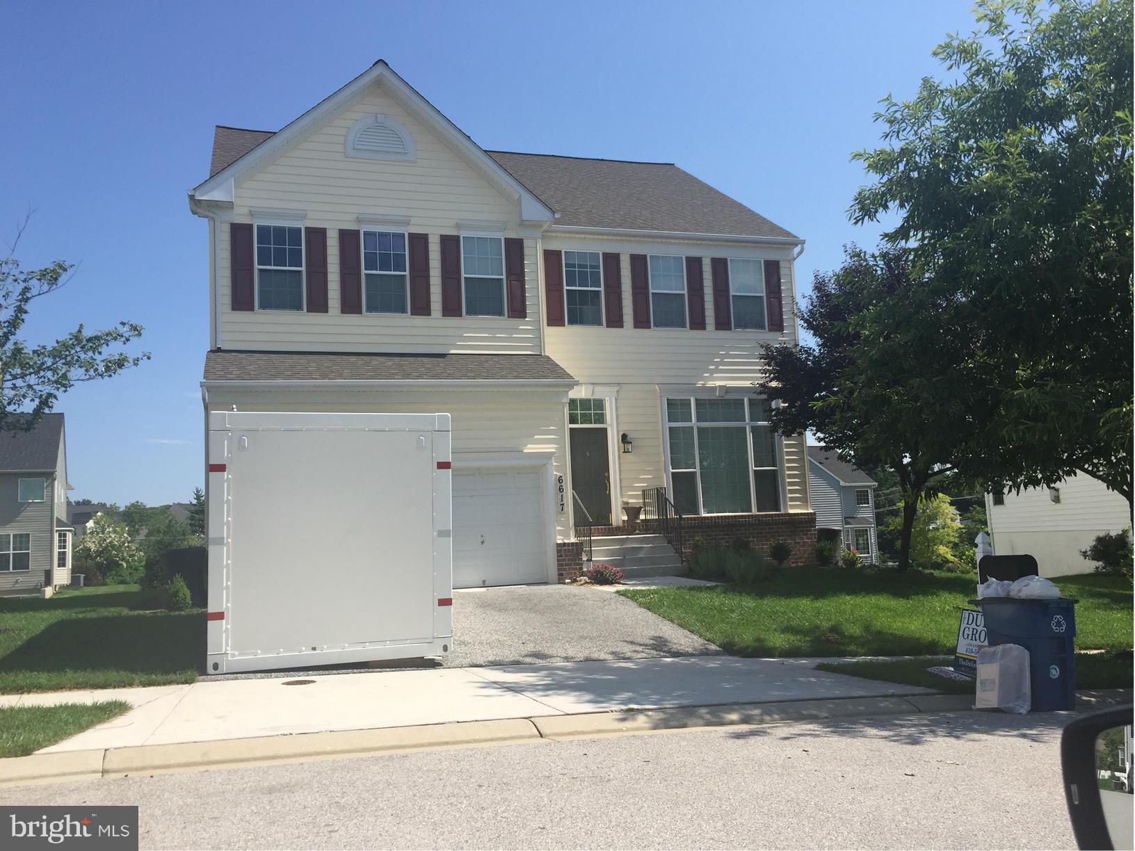 6617 Pebble Brooke Road Baltimore, MD 21209 - Photo 1 of 1 front view of a house with a yard