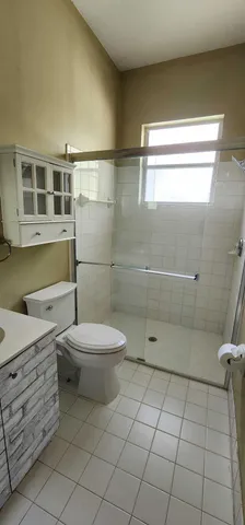 a bathroom with a toilet a sink and shower