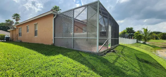 a backyard of a house with lots of green space and porch