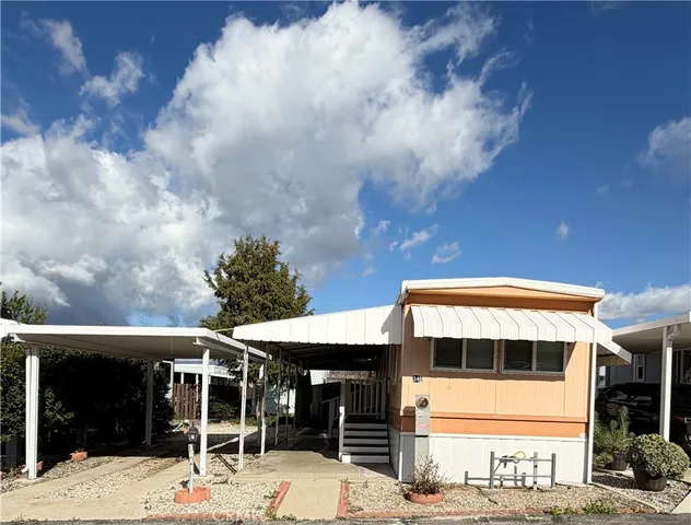 a front view of a building with a garden