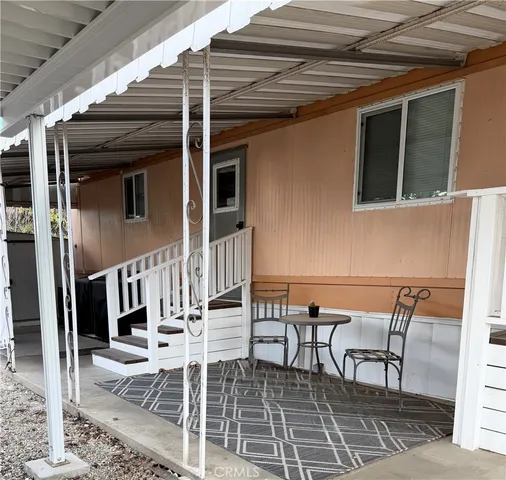a view of a patio with table and chairs