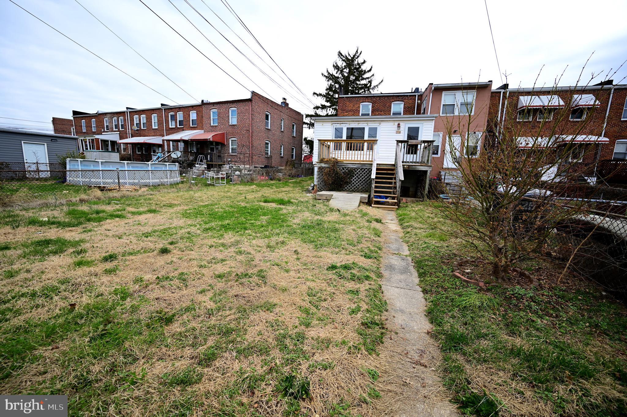 2952 Sollers Point Road, Unit B Dundalk, MD 21222 - Photo 36 of 37 a backyard of a house with yard and outdoor seating