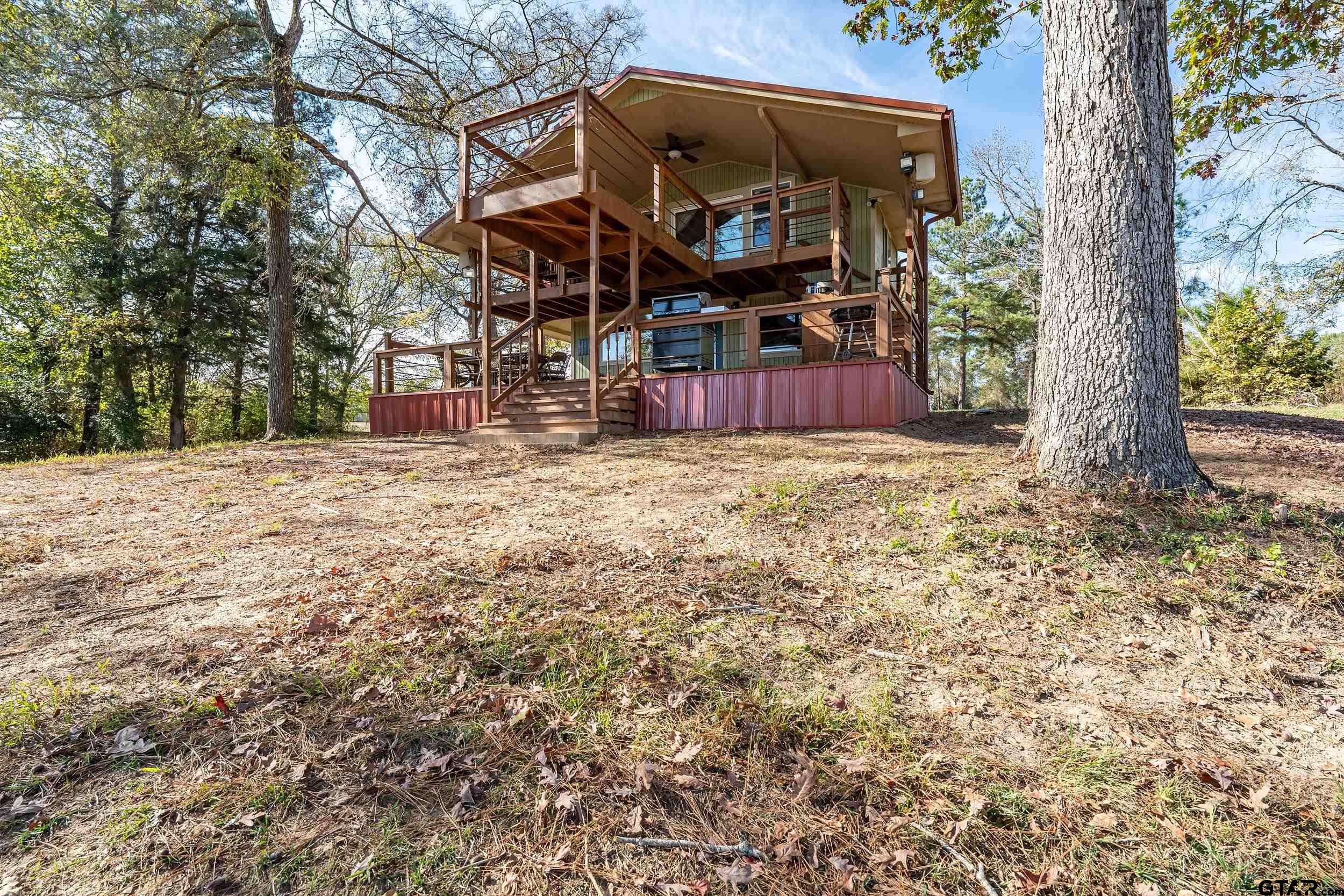 197 Cr 2304 Rusk Tx 75785 Rusk, TX 75785 - Photo 18 of 33 a view of a backyard with wooden fence and a large tree