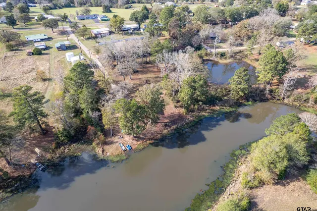 an aerial view of a houses with yard