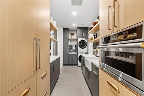 a kitchen with a refrigerator and a stove top oven