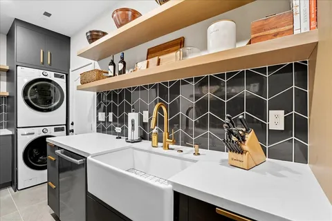 a utility room with sink dryer and washer