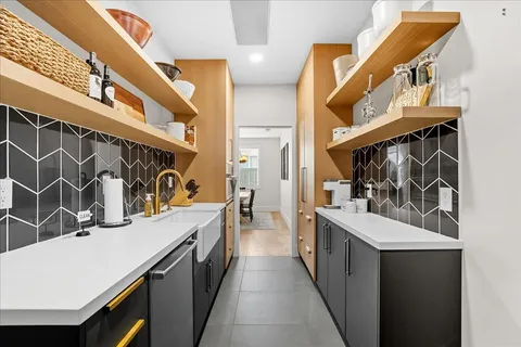 a kitchen with stainless steel appliances a sink and a refrigerator