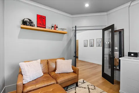 a bedroom with a bed and a chandelier