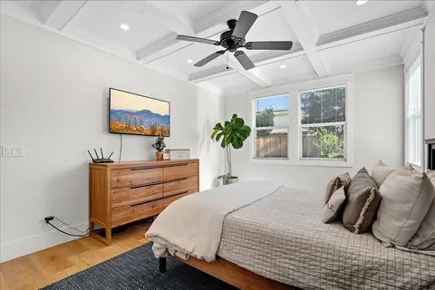 a bedroom with bed and a chandelier