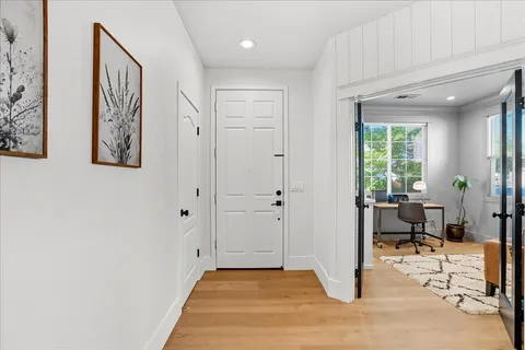 a view of a livingroom with a dinning area wooden floor and a window