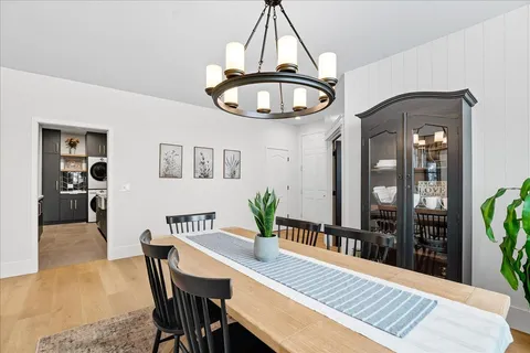 a view of a dining room with furniture and chandelier