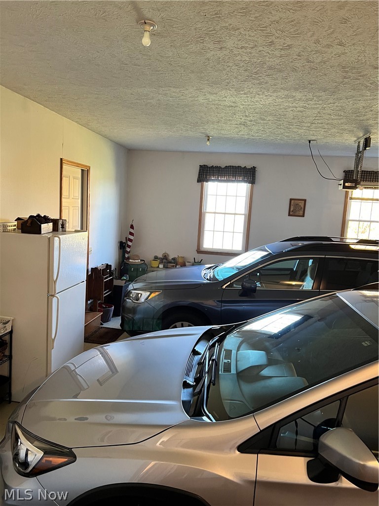 8160 Greenwich Road Lodi, OH 44254 - Photo 26 of 29 Additional man-door going out to the large front porch. Garage refrigerator stays.