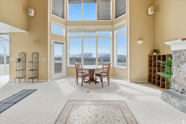 2887 View Crest Circle North Logan, UT 84341 - Photo 12 of 37 Carpeted dining room with a mountain view and a stone fireplace