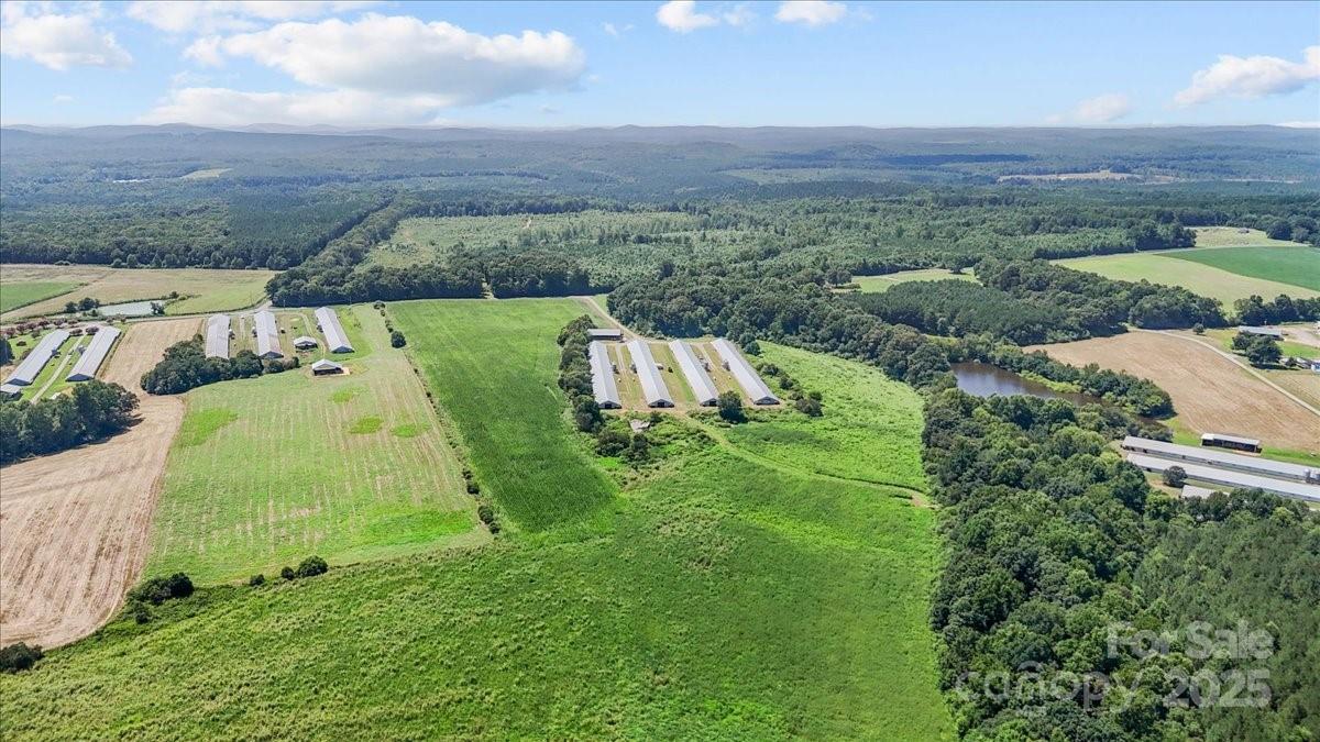 an aerial view of a house with yard and green space
