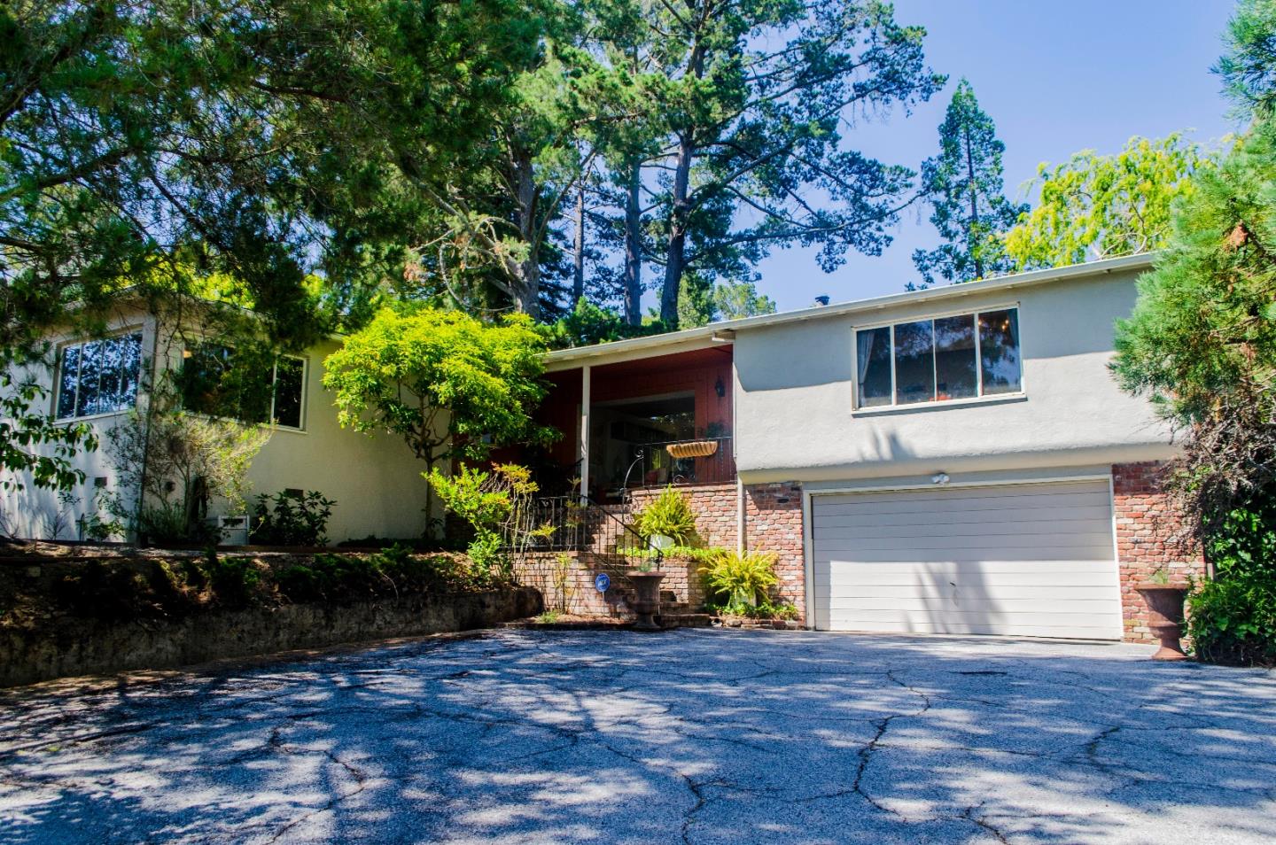 940 Black Mountain Road Hillsborough, CA 94010 - Photo 1 of 20 a front view of a house with a yard and a garage