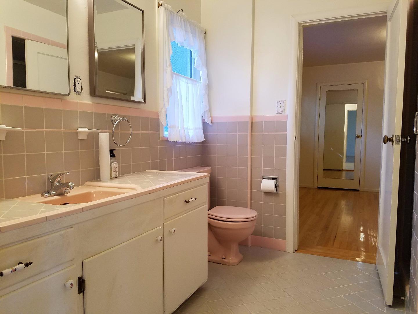 940 Black Mountain Road Hillsborough, CA 94010 - Photo 13 of 20 a bathroom with a sink a toilet and a mirror