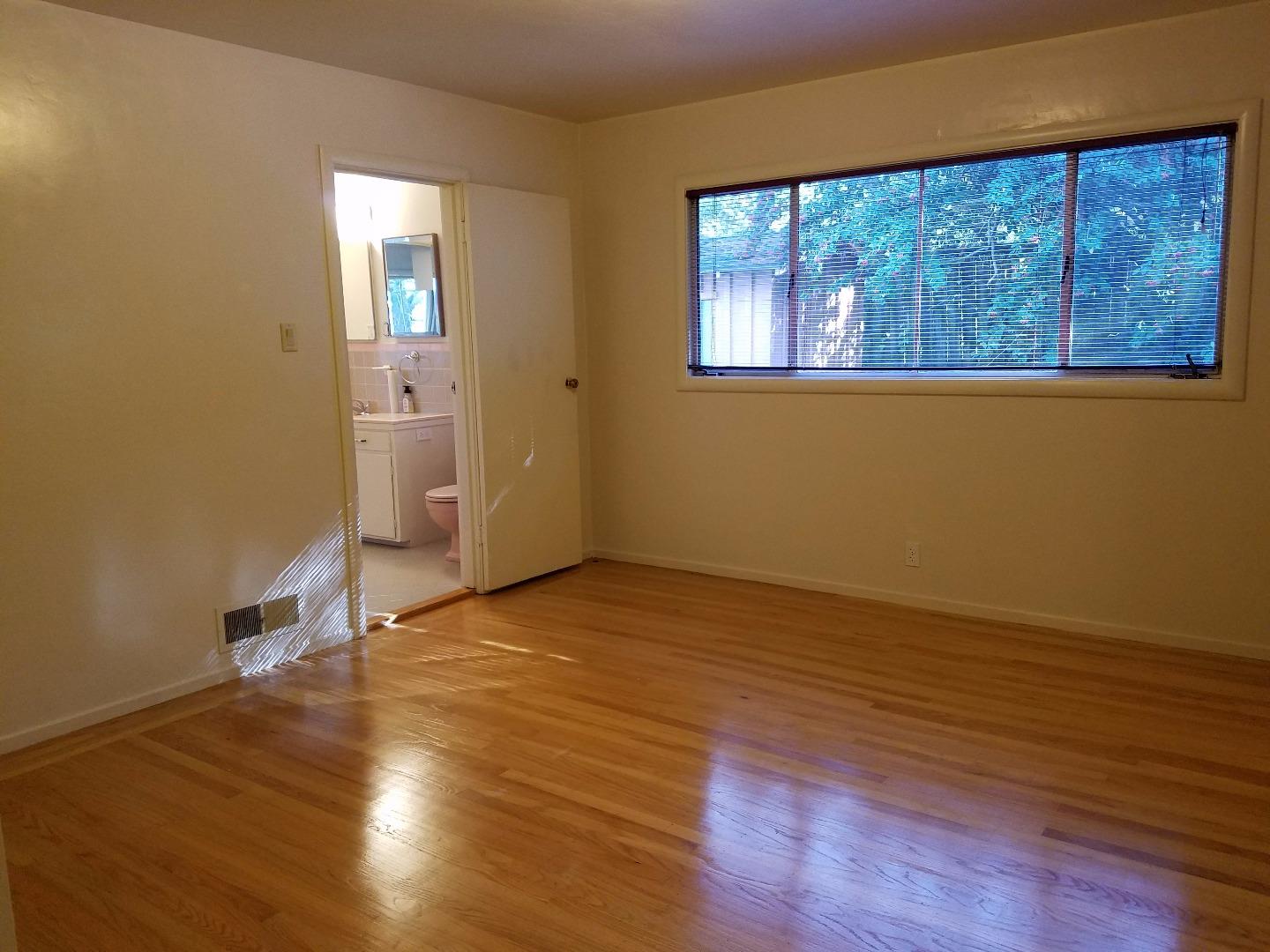 940 Black Mountain Road Hillsborough, CA 94010 - Photo 14 of 20 a view of an empty room with wooden floor and a window