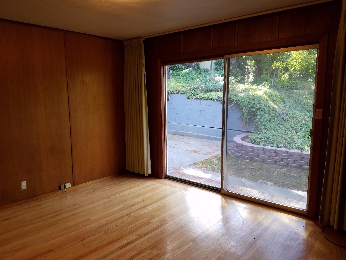 940 Black Mountain Road Hillsborough, CA 94010 - Photo 15 of 20 a view of a room with wooden floor and large window