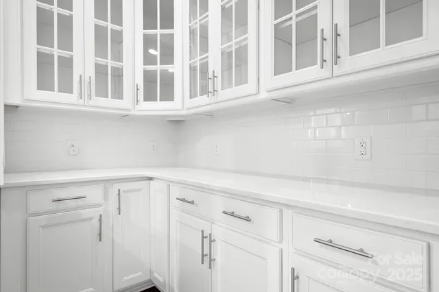a view of white cabinets and sink