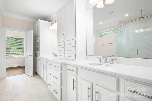 a bathroom with a shower and a glass door