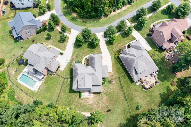 an aerial view of residential house with outdoor space and swimming pool