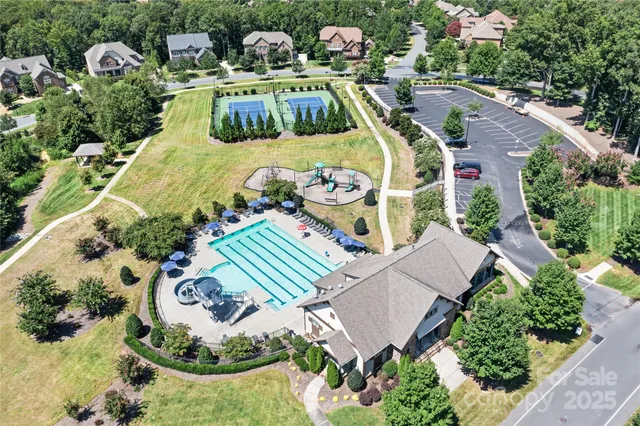 a view of a house with pool and chairs