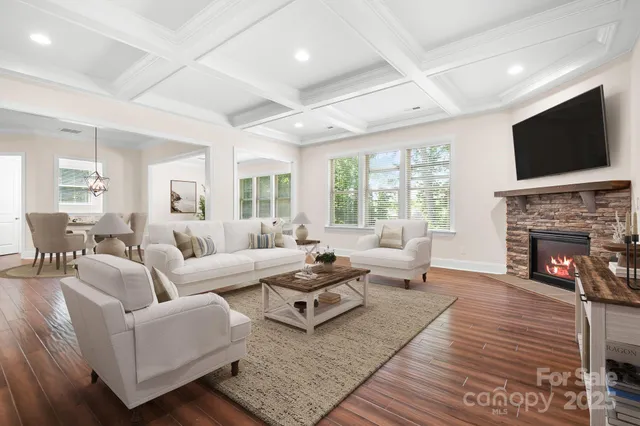 a living room with fireplace furniture and a flat screen tv