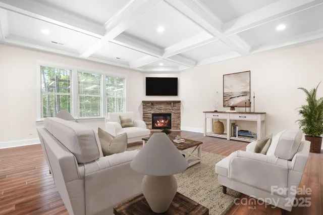 a living room with furniture a fireplace and a large window