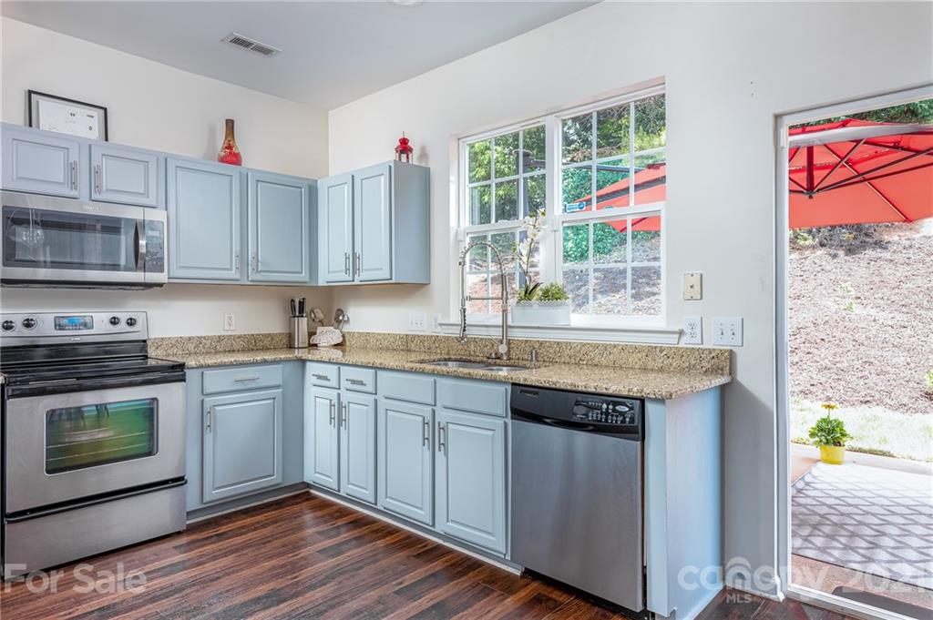 9239 Hillston Ridge Road Huntersville, NC 28078 - Photo 15 of 38 a kitchen with granite countertop a stove a sink and a microwave