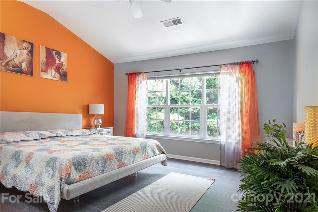 9239 Hillston Ridge Road Huntersville, NC 28078 - Photo 17 of 38 a bedroom with a large bed and a potted plant