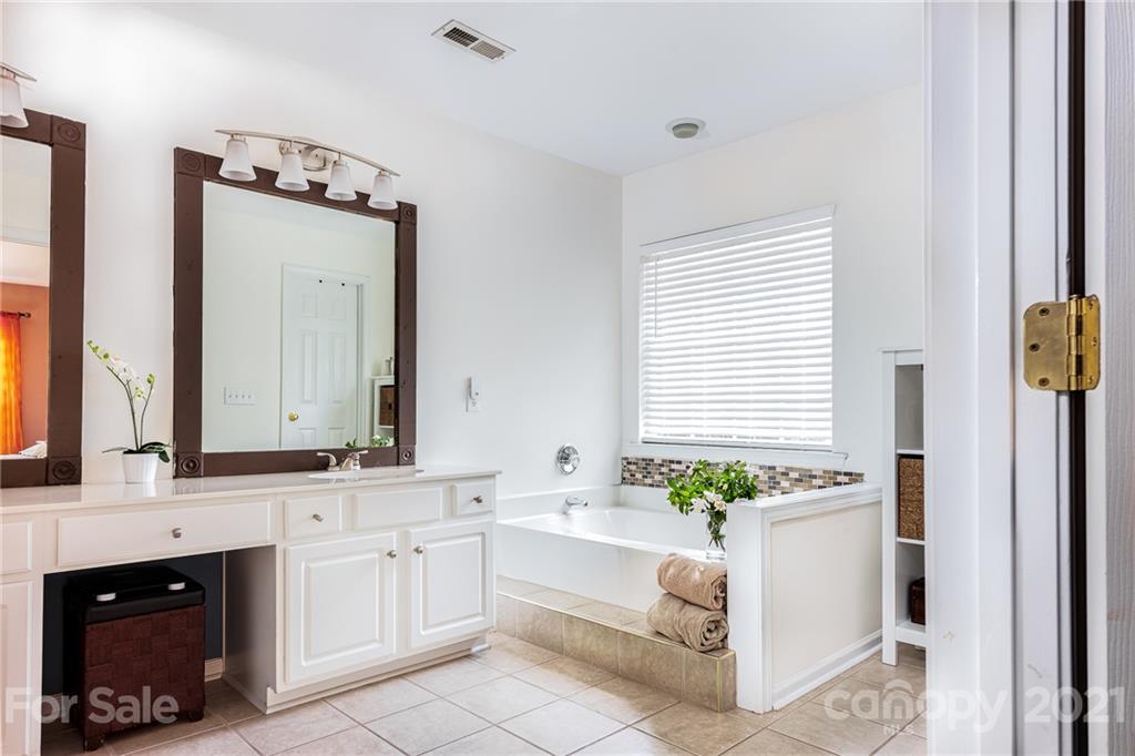 9239 Hillston Ridge Road Huntersville, NC 28078 - Photo 22 of 38 a bathroom with a granite countertop sink and a mirror