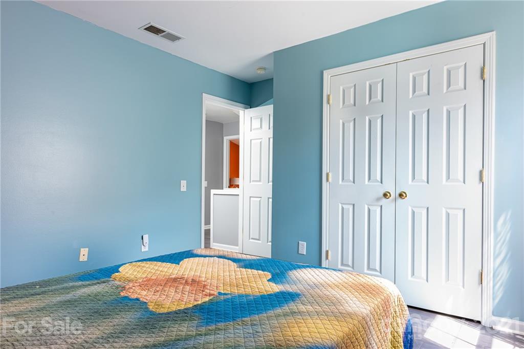 9239 Hillston Ridge Road Huntersville, NC 28078 - Photo 24 of 38 a bedroom with a bed and wooden floor