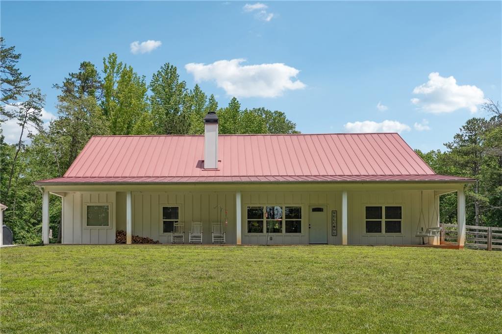 3556 Kelly Bridge Road Dawsonville, GA 30534 - Photo 1 of 1 a front view of a house with a garden