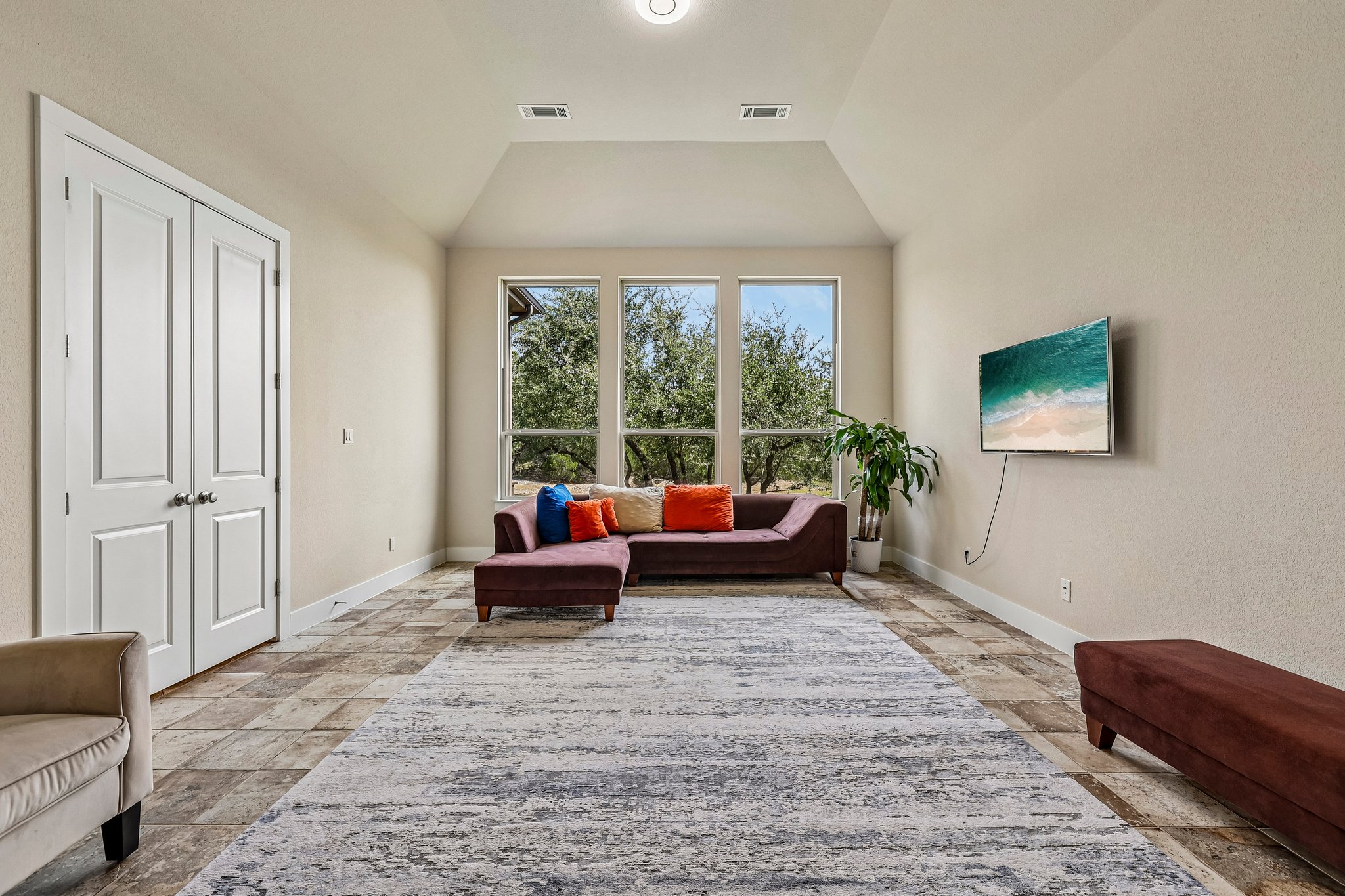 1705 Parten Rnch Parkway Austin, TX 78737 - Photo 21 of 39 A spacious living area with vaulted ceilings and large windows provides an inviting atmosphere and views of the outdoors.