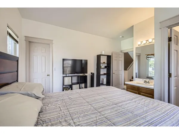 a bedroom with a bed and a large mirror in it