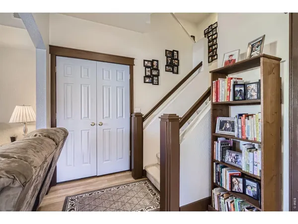 a living room with furniture and a book shelf