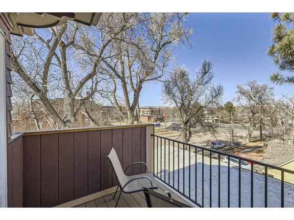 a view of outdoor space with deck and wooden fence