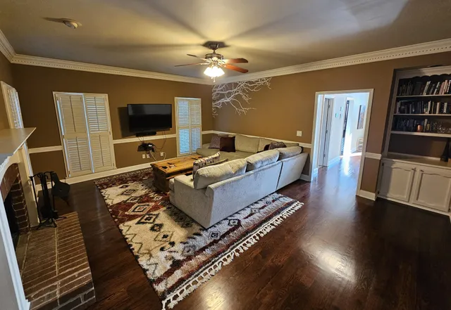 a living room with furniture flat screen tv and a fireplace