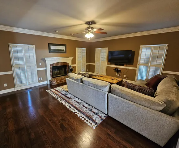 a living room with furniture fireplace and flat screen tv
