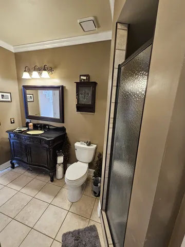 a bathroom with a toilet mirror vanity and a sink
