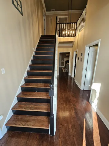 a view of entryway and hall with wooden floor