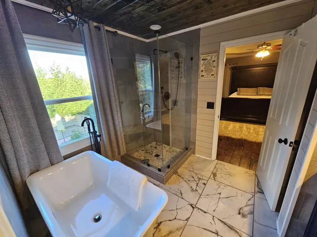 a bathroom with a tub and a shower