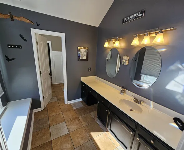 a bathroom with a double vanity sink and a mirror